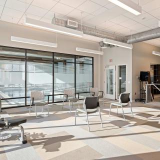 A modern waiting area with chairs arranged in a spacious and bright interior.