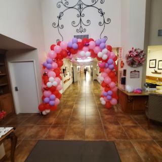 A vibrant balloon arch marking the entrance to a festive event.