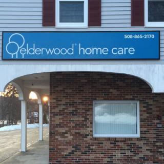 Elderwood Home Care signage on a brick building.