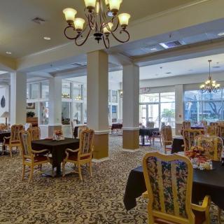 A spacious dining area with elegant furnishings and natural light.