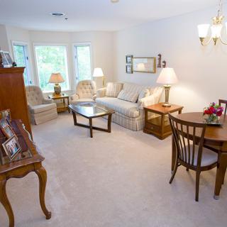 A cozy living room with a sofa, chairs, and various pieces of furniture arranged tastefully.