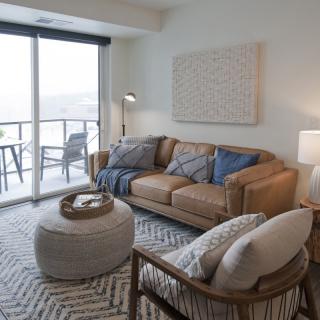 Modern living room with a cozy sofa and a balcony view.