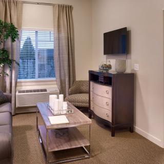 A cozy and modern living room with a television, sofa, and elegant decor.