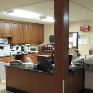 An office reception area with desks and equipment.