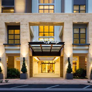 Elegant hotel entrance illuminated at night.