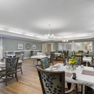 A well-decorated dining room with elegant furnishings and floral centerpieces.