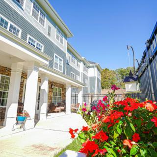 A sunny day at a residential building with a vibrant garden.