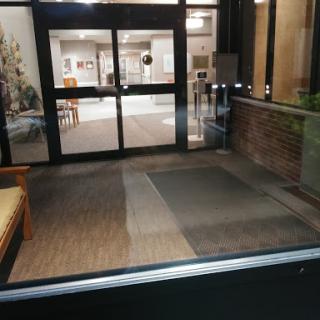 A view of the entrance lobby with seating, showcasing the interior design and flooring.