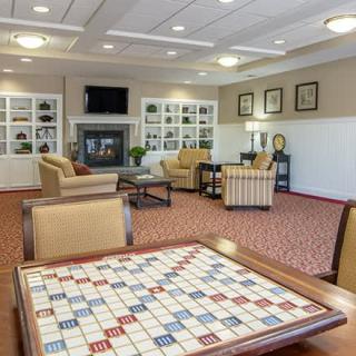A cozy lounge area featuring comfortable seating and a game table.