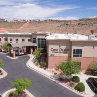 A medical facility with a parking lot in a desert landscape.