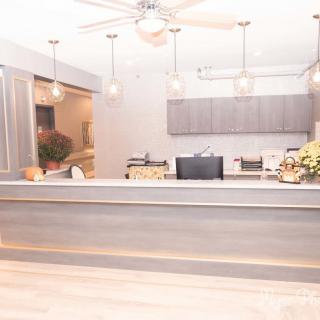 A modern reception area featuring stylish lighting and a sleek counter design.
