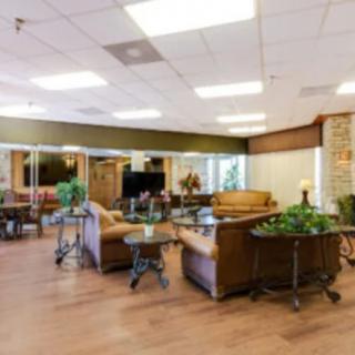 A cozy lobby area with comfortable seating and decorative plants.