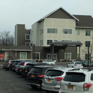 A modern hotel with a spacious parking lot.