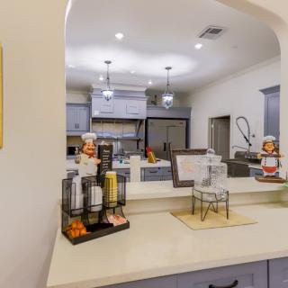 A modern kitchen interior featuring a coffee station on the countertop.