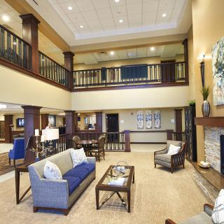 A modern and spacious hotel lobby with comfortable seating and a two-story design.