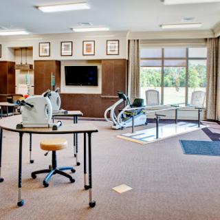 A well-equipped rehabilitation gym featuring exercise machines and a spacious layout.