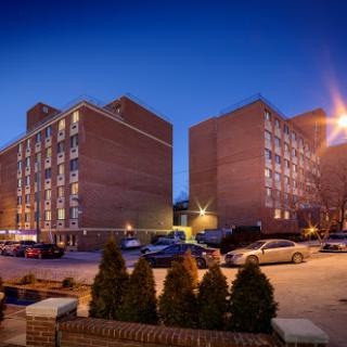 An apartment complex illuminated at night, showcasing urban living in a bustling environment.