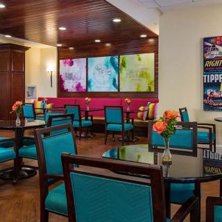A vibrant dining area featuring colorful seating and modern artwork on the walls.