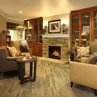 A cozy living room with a warm fireplace and comfortable seating.