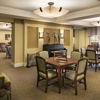 A cozy indoor lounge area with a table, chairs, and elegant decor.