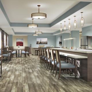 Modern dining area with a bar counter and stylish lighting.