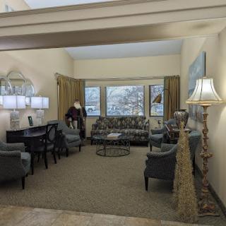 A cozy and elegantly designed living room featuring comfortable seating and a pleasant window view.