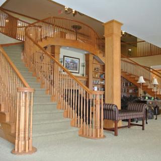A beautifully designed hotel lobby featuring a wooden staircase and comfortable seating.