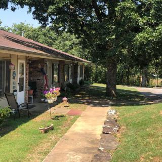 A suburban house with a front yard and sidewalk on a sunny day.