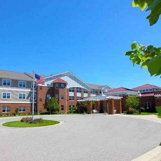 A healthcare facility with a modern architectural design under a clear blue sky.