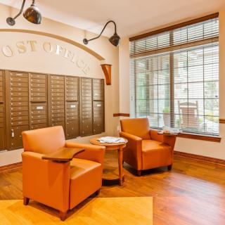 A cozy mailroom with comfortable seating and ample natural light.