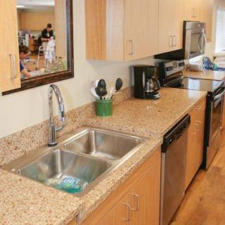 Modern kitchen with granite countertops and stainless steel appliances.