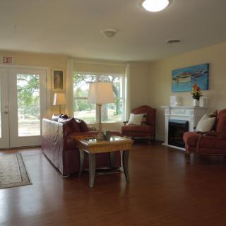 A cozy living room with comfortable seating and a fireplace.