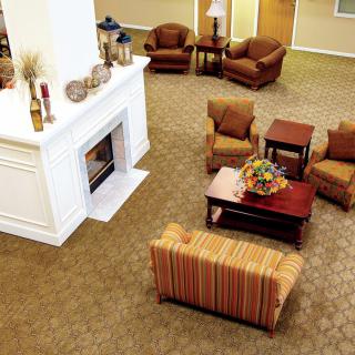 A cozy living room with a fireplace, comfortable seating, and a coffee table.