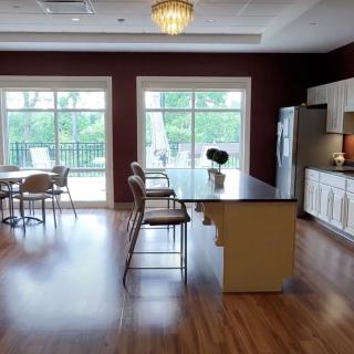 A spacious modern kitchen with a large island and plenty of natural light from big windows.