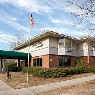 Exterior view of a hospital building with an American flag.