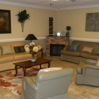 Cozy living room with sofas, armchairs, and a coffee table.