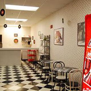 A retro-style diner with checkered floors and vintage decor.