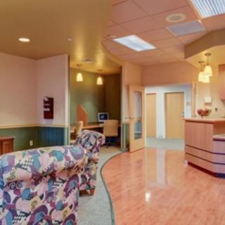 A welcoming hospital waiting room with comfortable seating and a reception desk.
