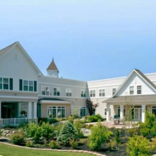 A large residential building with landscaped gardens.