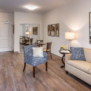 A cozy living room with stylish furniture and wooden flooring.