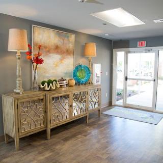 A beautifully decorated lobby featuring stylish furniture, art, and ample natural light.