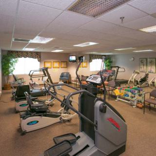 A gym equipped with various exercise machines and fitness equipment.