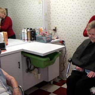 Elderly individuals enjoying a visit to the hair salon.