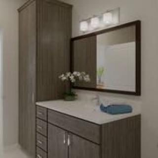 A modern bathroom vanity with a large mirror and cabinet storage.