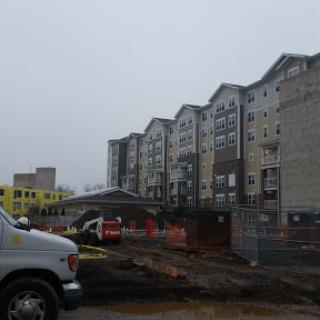 A view of an apartment complex under construction on a cloudy day.