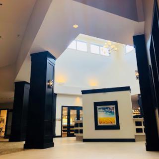 A modern lobby showcasing elegant architecture and ample natural light.