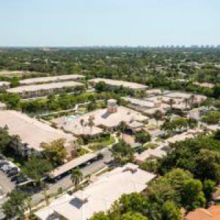 Aerial view of a suburban residential area with trees and buildings.