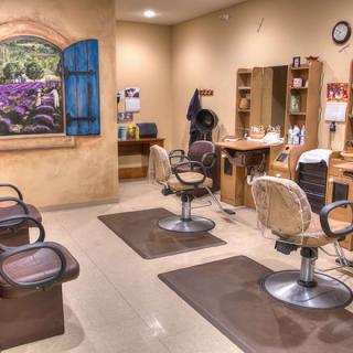 Interior of a hair salon featuring styling chairs and mirrors.