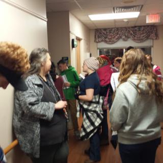 A lively gathering of people in a warmly decorated indoor space.