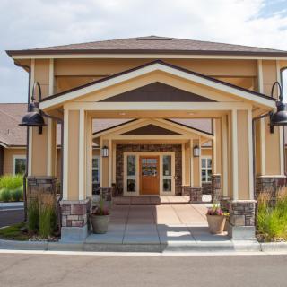 A front view of a residential building entrance with a covered walkway.